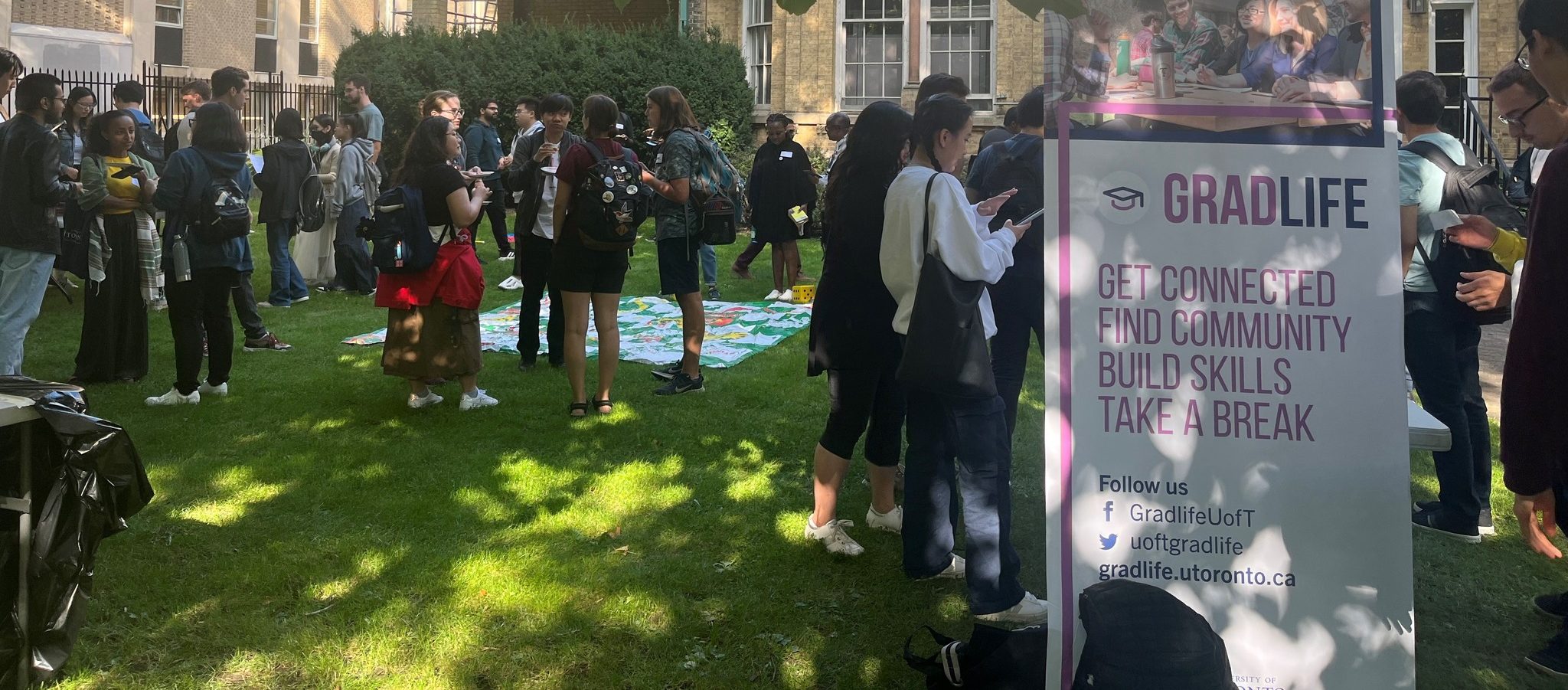 Grad students gathered around the Cumberland House front lawn during a Gradlife event.