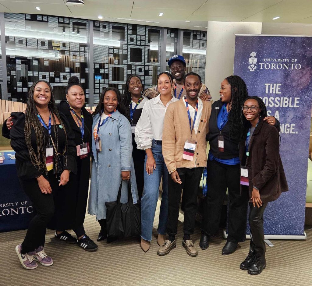 Group of students and staff smiling during a Black students career event.