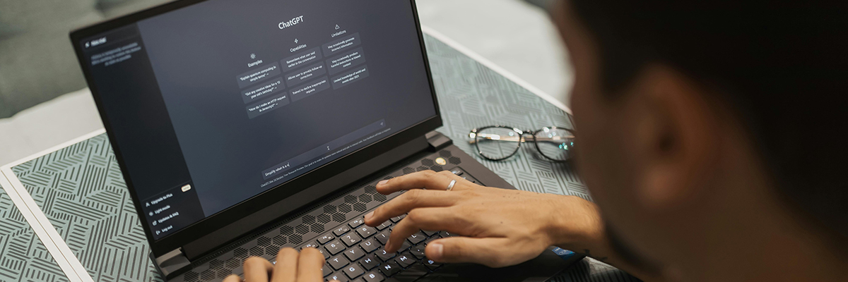 Person at a laptop computer. The screen shows the ChatGPT interface.