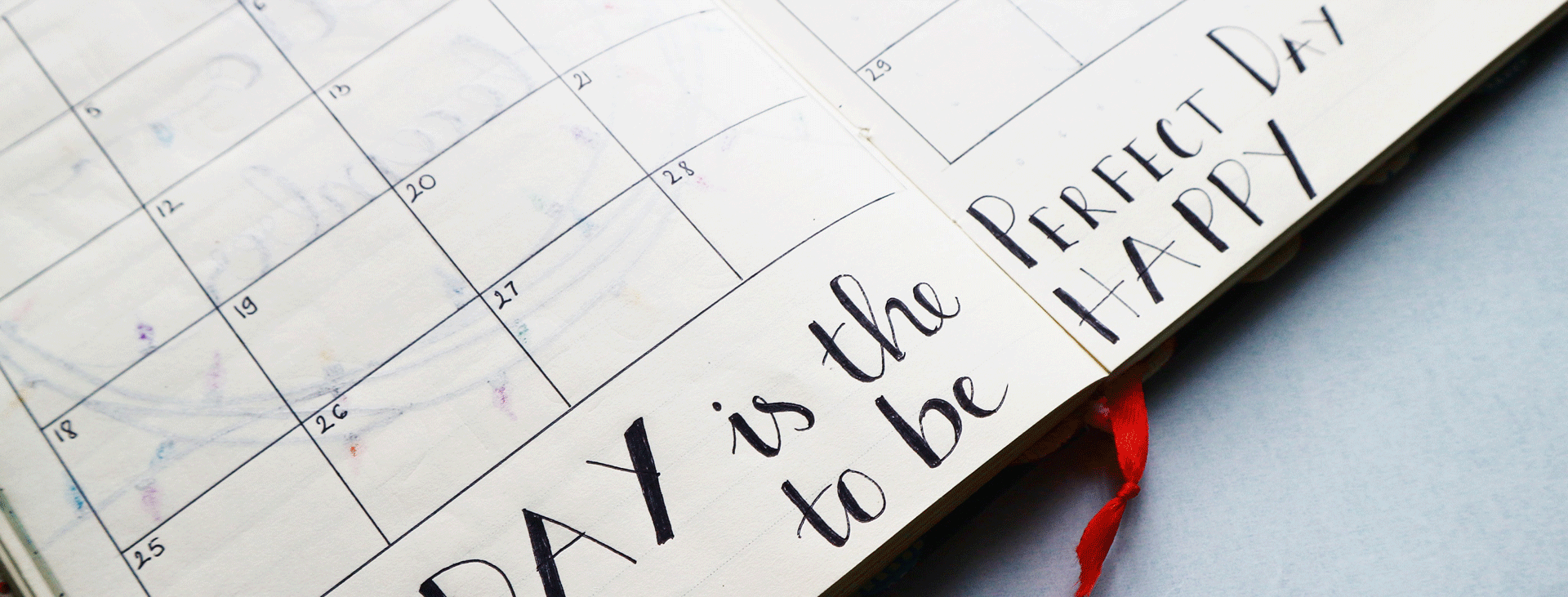 Faded view of a monthly calendar with Happy Perfect Day written on it