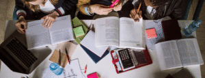 Students at table with books and other study materials