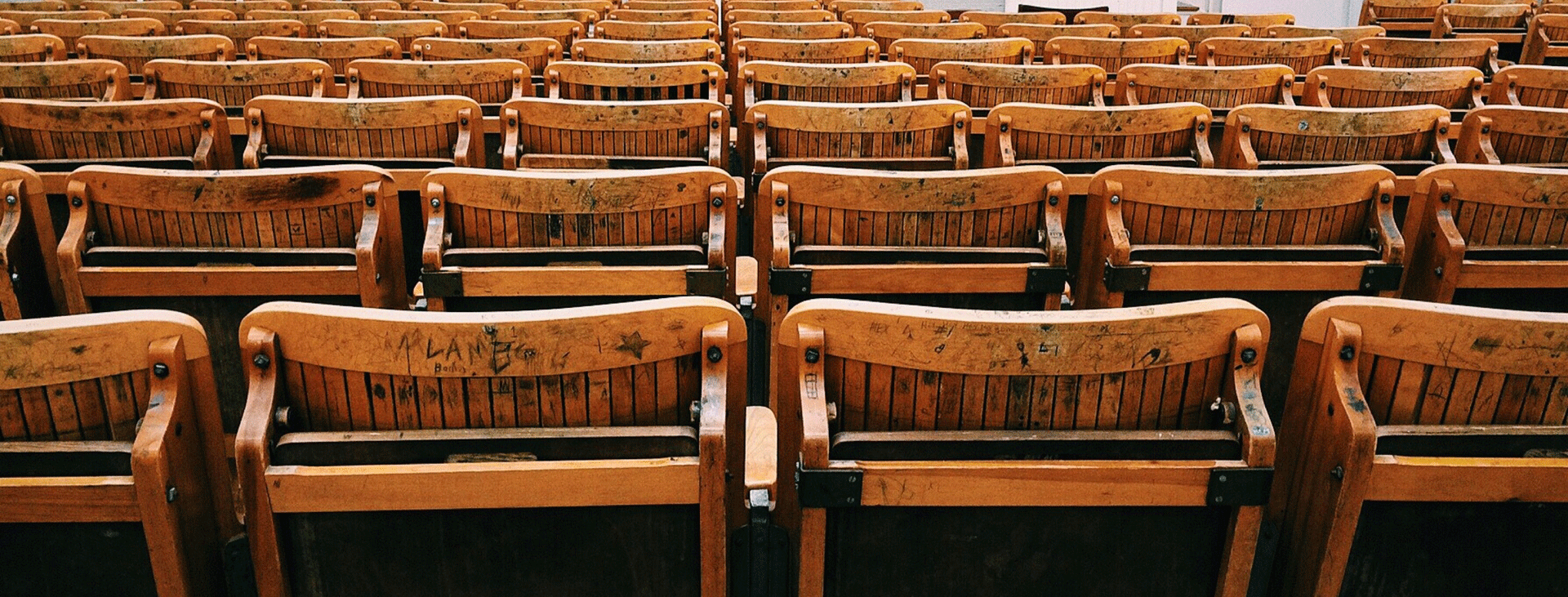 The backs of old school wooden classroom chairs