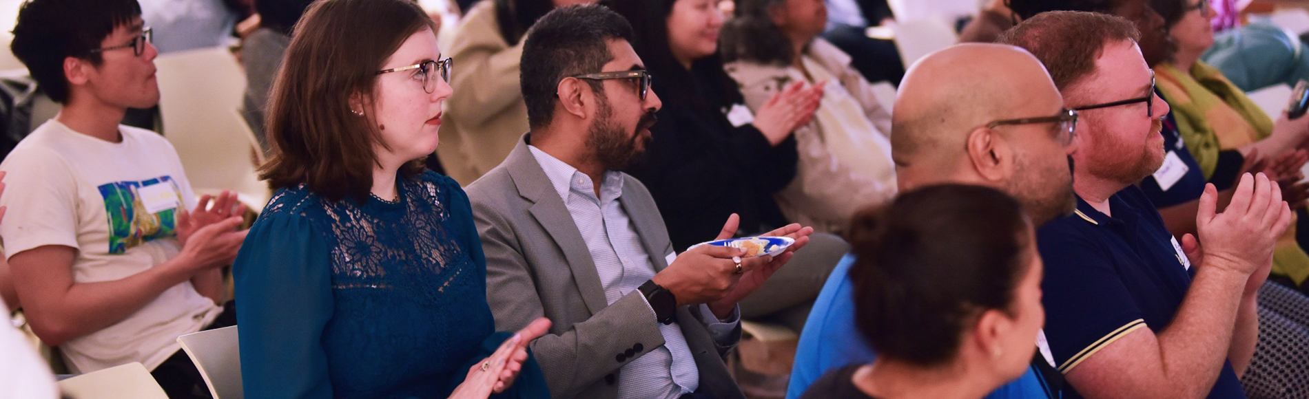 Group of people seated watching a presenetation