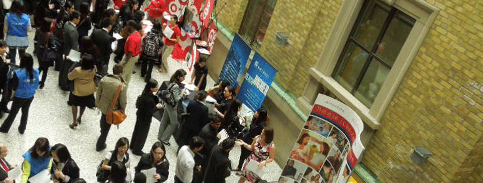 A crowd of people attending a career fair