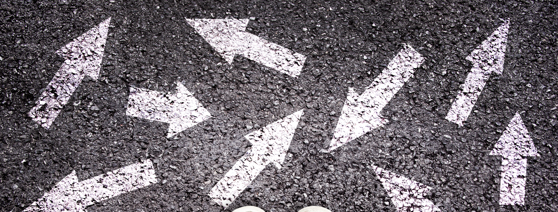 Random arrows chalked on asphalt