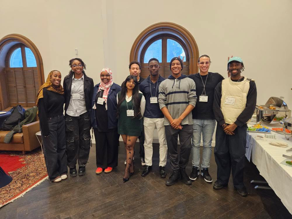 A group of 9 students and staff smiling and standing together during the Building Futures 2025 event.