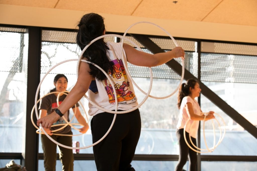 Indigenous students Hoop Dancing in Goldring Centre.