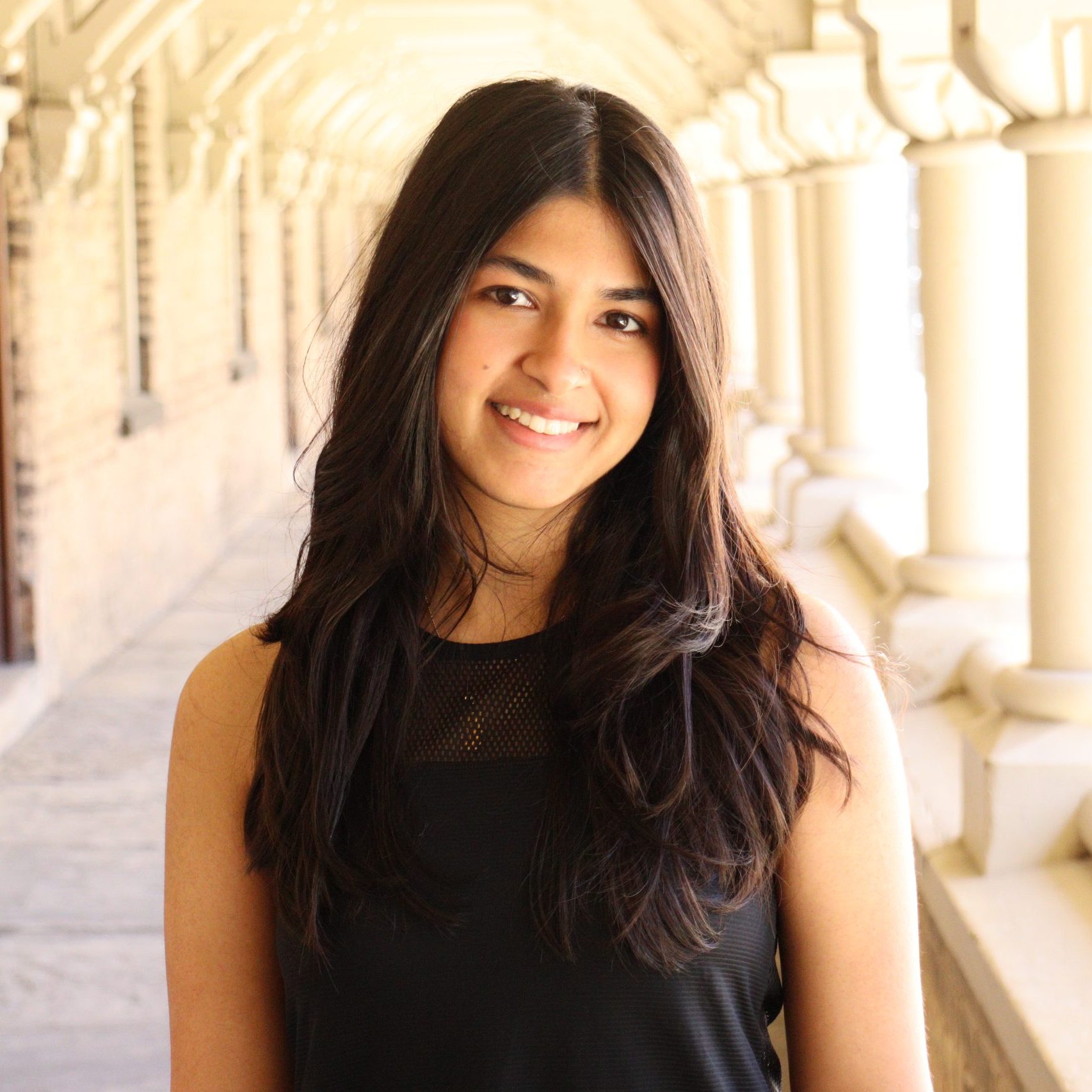 Headshot of Fiza smiling.