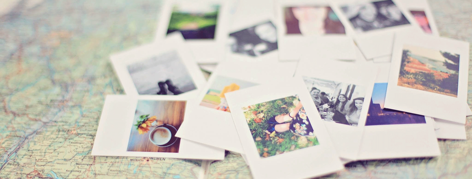 A pile of blurred polaroids on a travel map