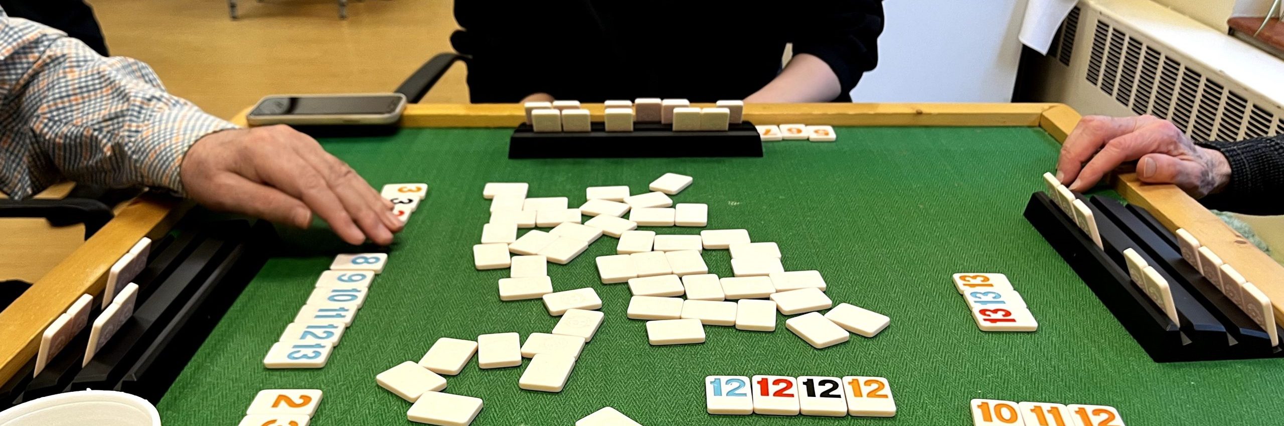 Students and seniors playing Rummikub.