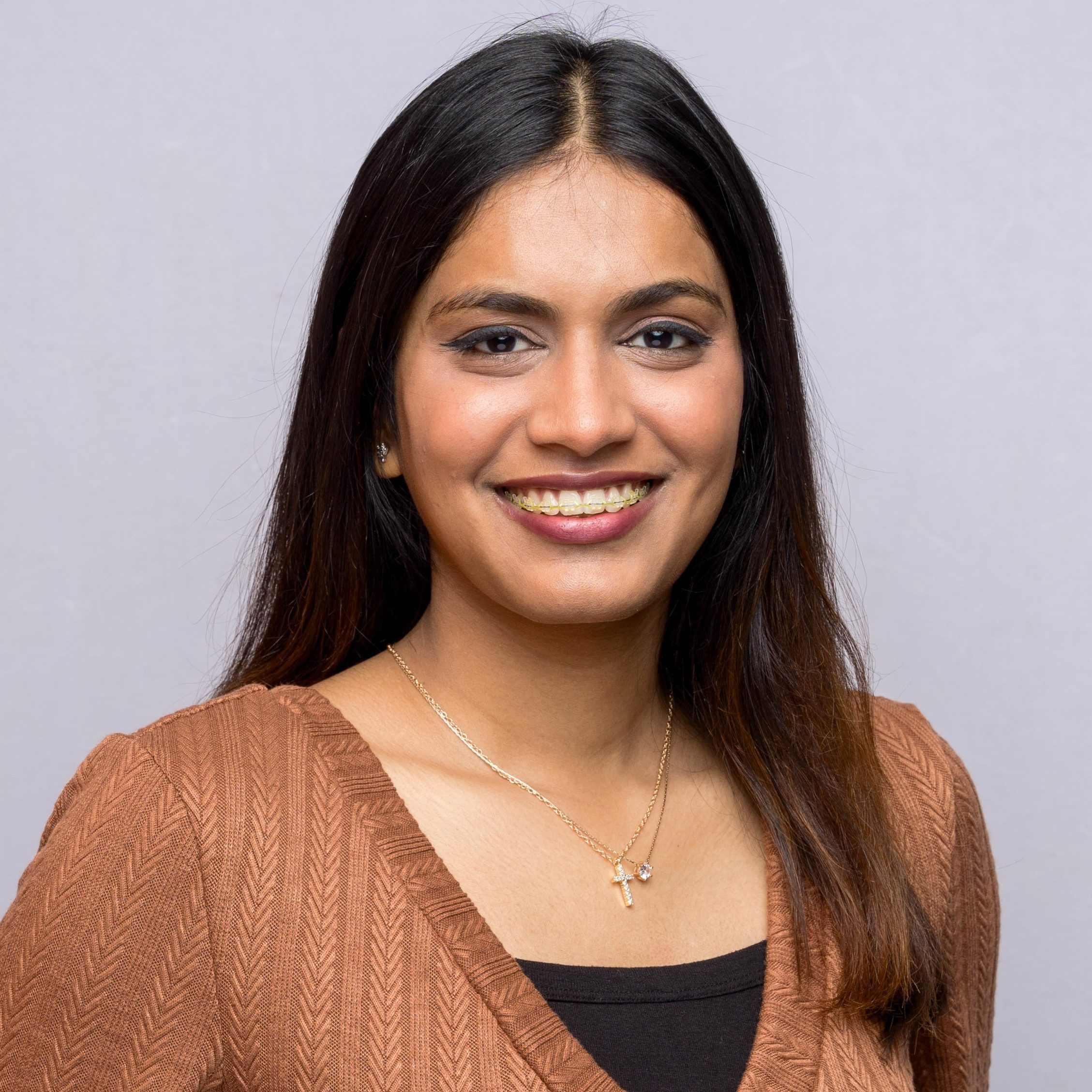 Headshot of Pooja smiling.