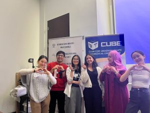Six students from CUBE making heart signs with their hands and posing together.