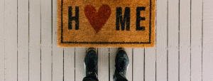 Welcome mat that says HOME with a heart where the O should be