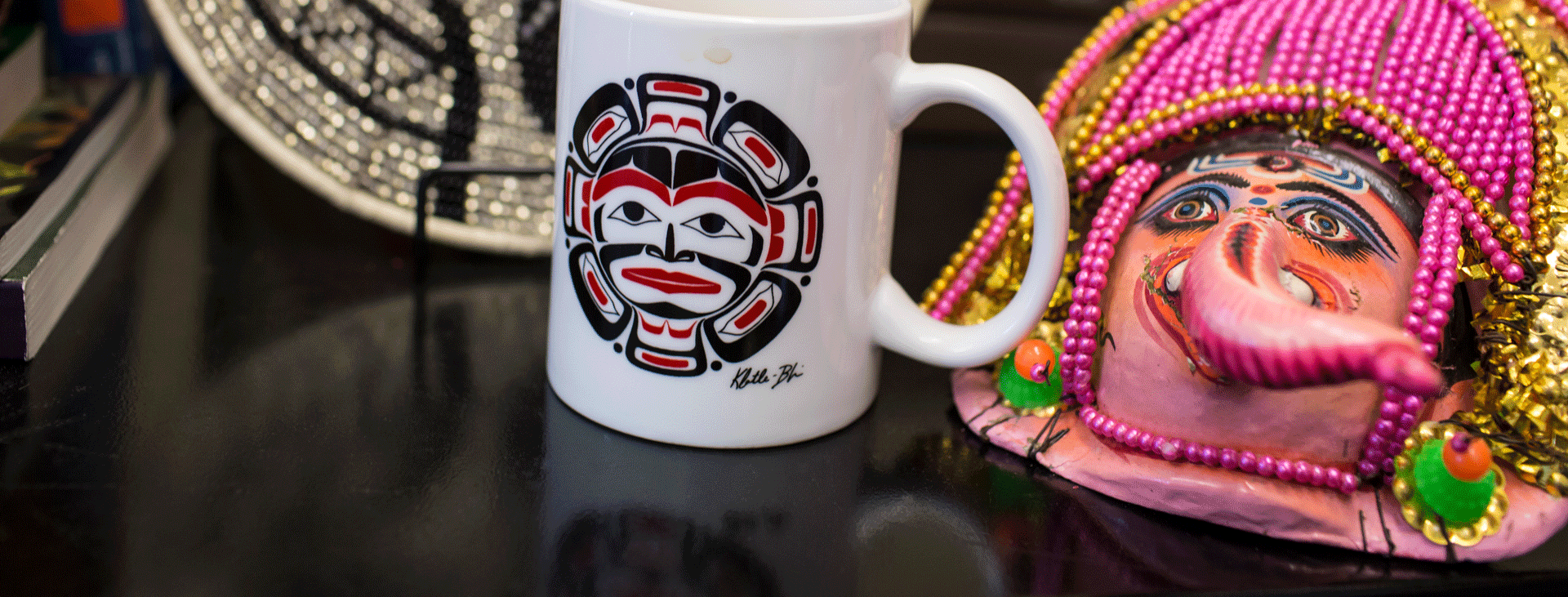Indigenous pattern on a mug and a decorative mask