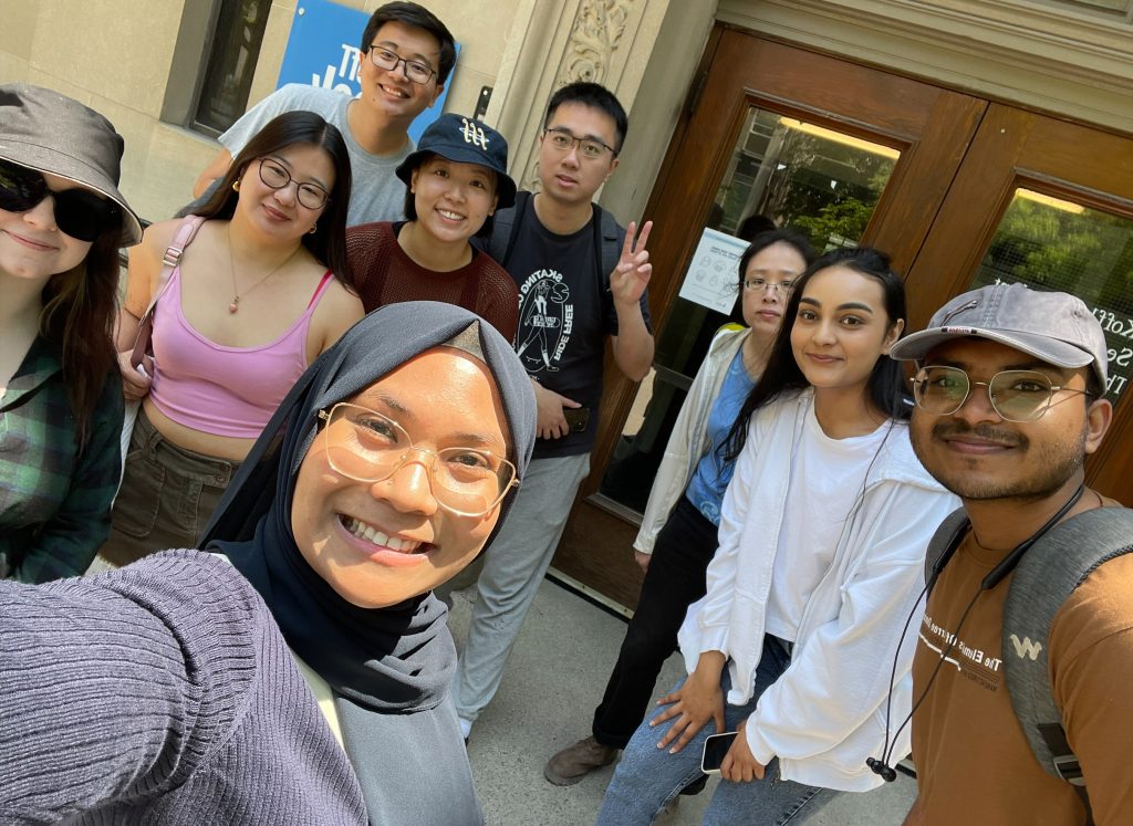 A group selfie of grad students in front of the Bookstore entrance.