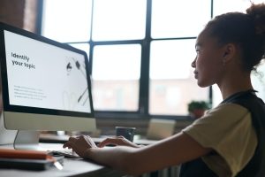 Side profile of woman using desktop monitor