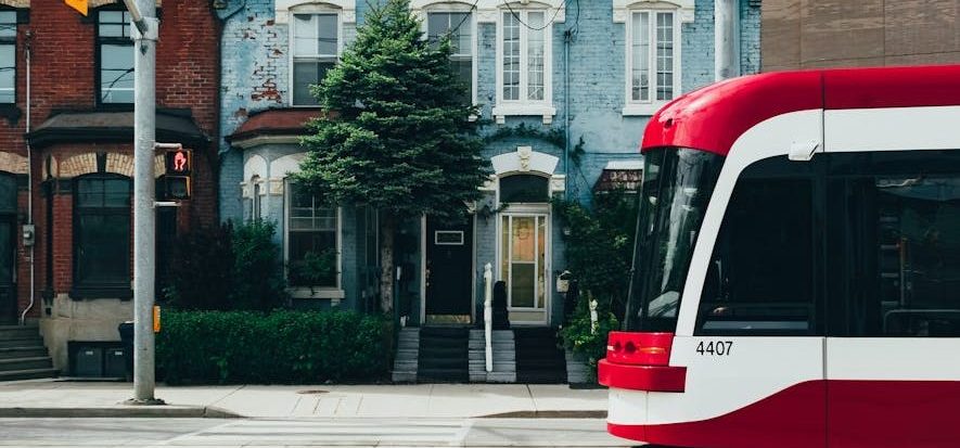 White and Red Cable Train in the Middle of the Street